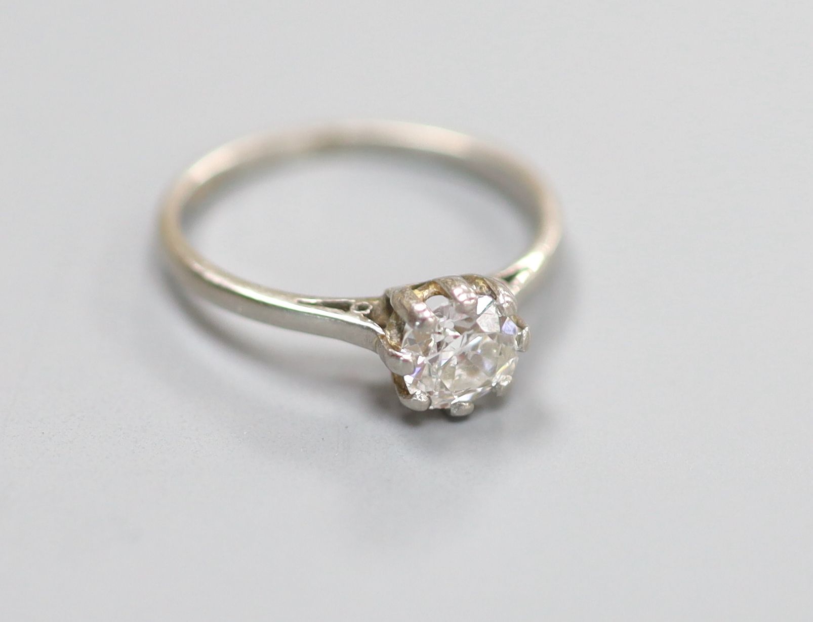 A white metal (stamped plat) and solitaire diamond ring
